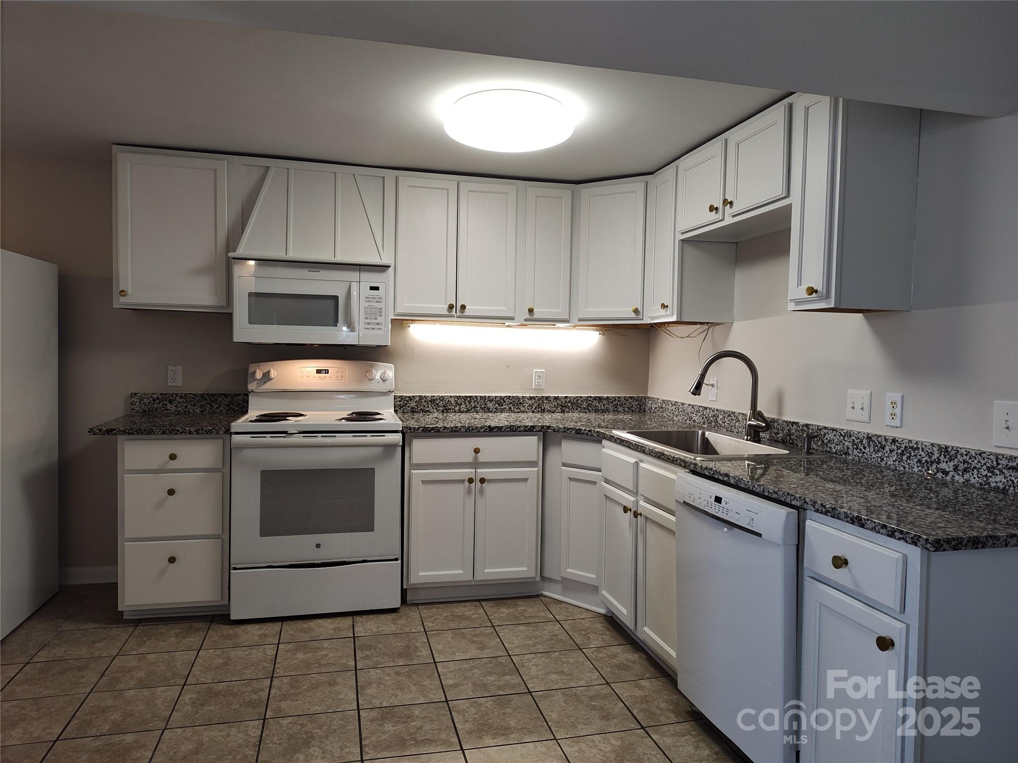 340 Hollis Road Charlotte, NC 28209 - Photo 4 of 21 a kitchen with a sink stove and cabinets
