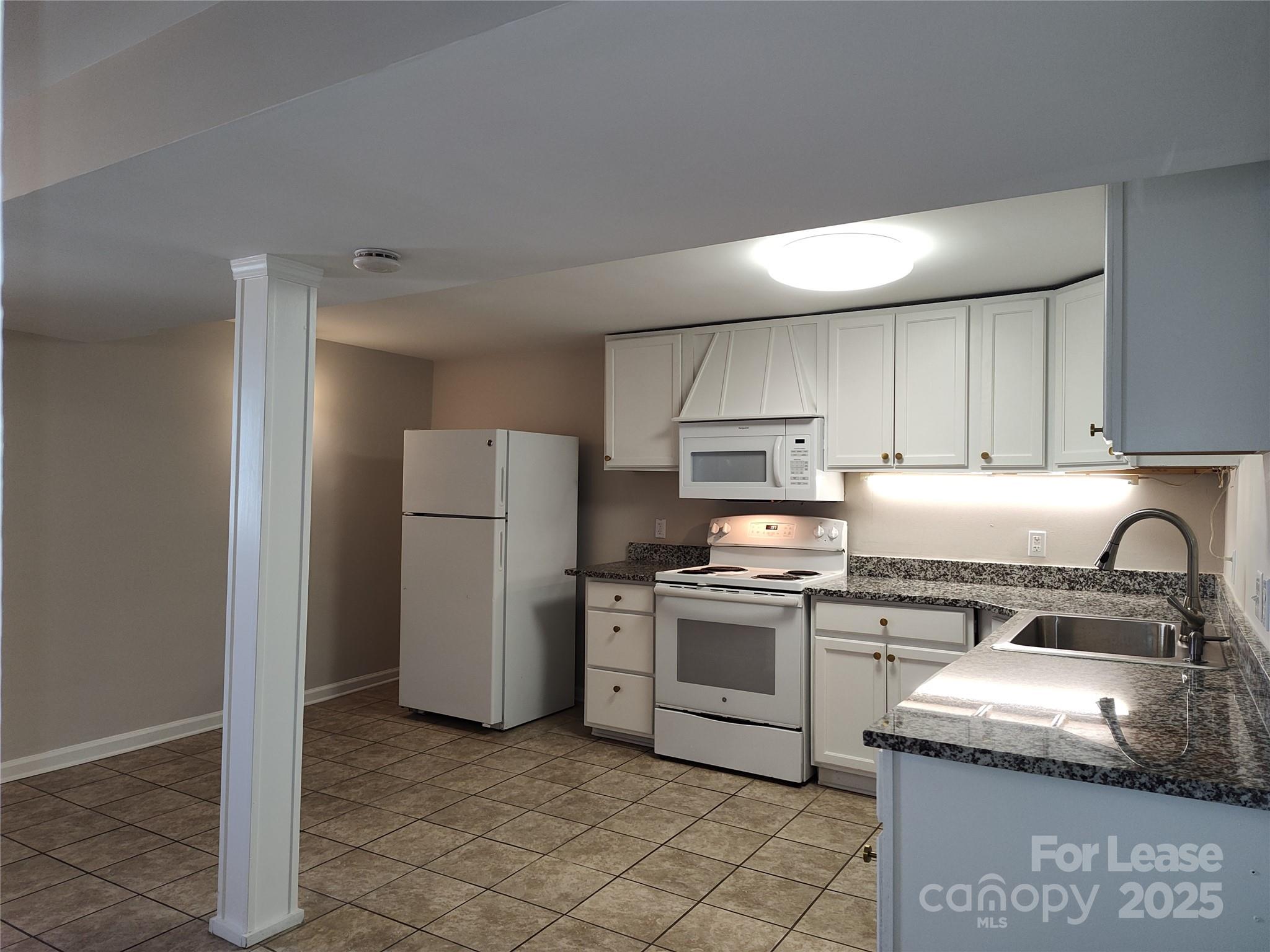 340 Hollis Road Charlotte, NC 28209 - Photo 6 of 21 a kitchen with a stove top oven and refrigerator