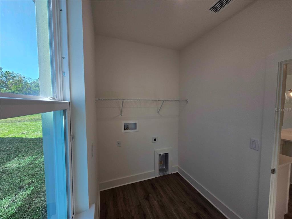 3352 Daybreak Run Loop Spring Hill, FL 34609 - Photo 12 of 15 a view of a small space with wooden floor and a window