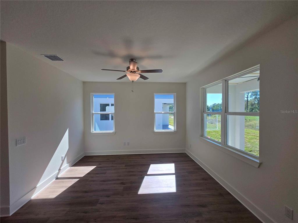 3352 Daybreak Run Loop Spring Hill, FL 34609 - Photo 5 of 15 a view of empty room with wooden floor and fan