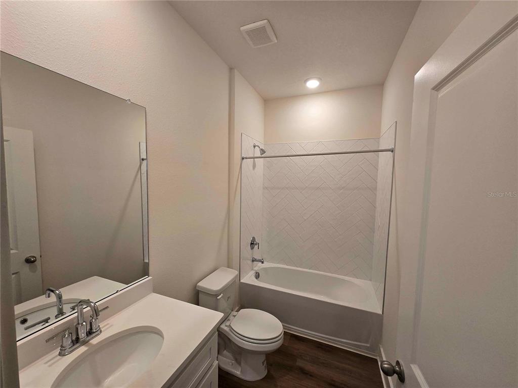 3352 Daybreak Run Loop Spring Hill, FL 34609 - Photo 10 of 15 a bathroom with a sink toilet vanity and shower