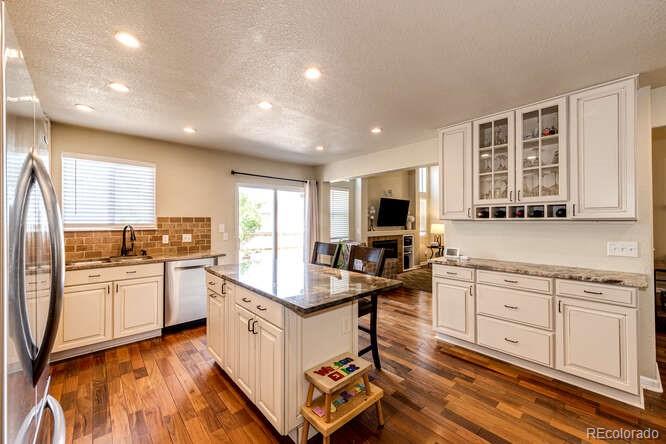 2016 West Ashwood Place Highlands Ranch, CO 80129 - Photo 12 of 40 a kitchen with white cabinets and appliances