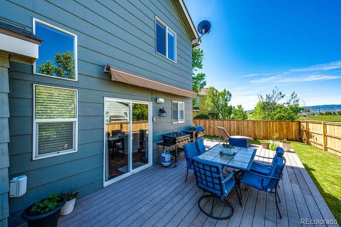2016 West Ashwood Place Highlands Ranch, CO 80129 - Photo 14 of 40 a backyard of a house with wooden floor outdoor seating and barbeque oven