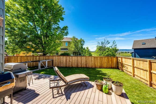 2016 West Ashwood Place Highlands Ranch, CO 80129 - Photo 16 of 40 a view of a backyard with furniture potted plants and wooden fence