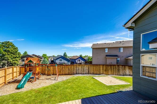2016 West Ashwood Place Highlands Ranch, CO 80129 - Photo 21 of 40 a view of a backyard with a slide