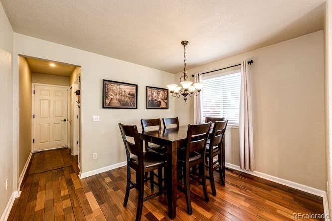 2016 West Ashwood Place Highlands Ranch, CO 80129 - Photo 22 of 40 a view of a dining room with furniture and chandelier