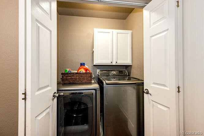 2016 West Ashwood Place Highlands Ranch, CO 80129 - Photo 24 of 40 a kitchen with stainless steel appliances granite countertop a stove and a refrigerator