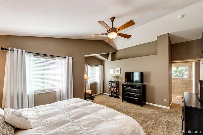 2016 West Ashwood Place Highlands Ranch, CO 80129 - Photo 27 of 40 a bedroom with a bed dresser and a flat tv screen