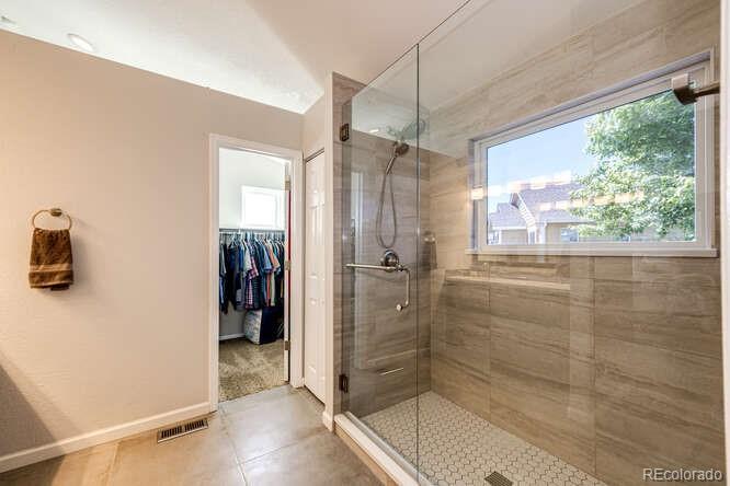 2016 West Ashwood Place Highlands Ranch, CO 80129 - Photo 28 of 40 a bathroom with a glass shower door