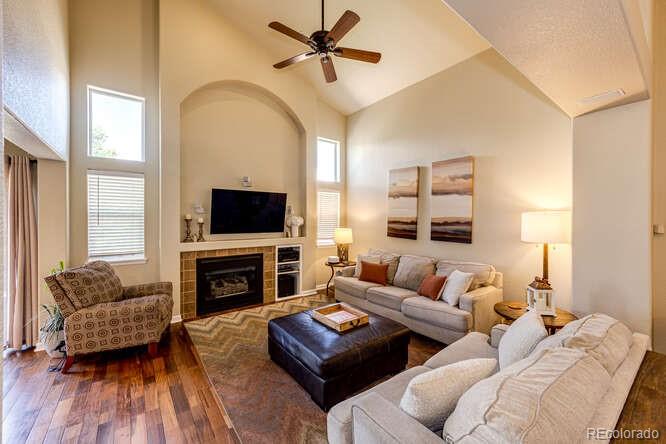 2016 West Ashwood Place Highlands Ranch, CO 80129 - Photo 7 of 40 a living room with furniture a flat screen tv and a fireplace