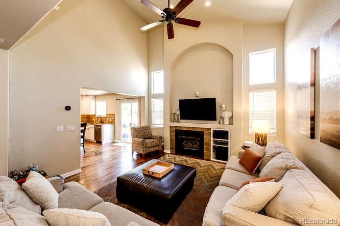 2016 West Ashwood Place Highlands Ranch, CO 80129 - Photo 8 of 40 a living room with furniture fireplace and a flat screen tv
