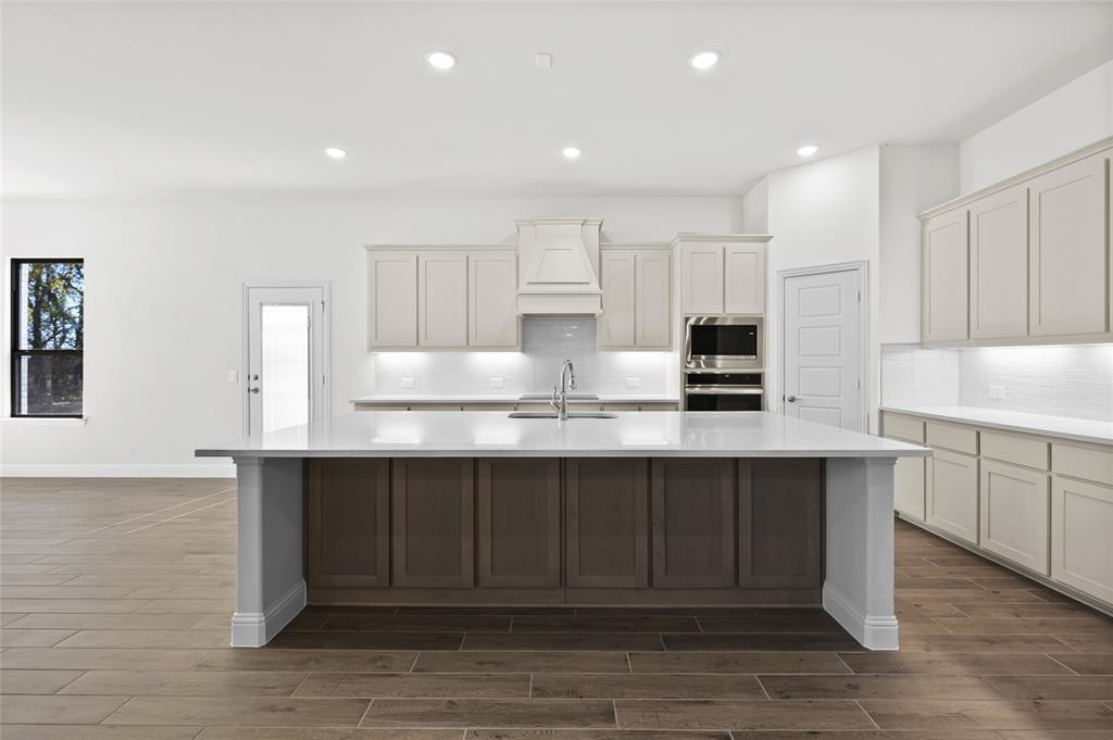 3 Beech Street Van Alstyne, TX 75495 - Photo 16 of 35 a kitchen with kitchen island granite countertop a sink and cabinets