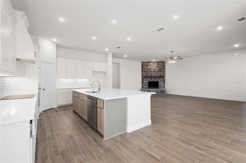 3 Beech Street Van Alstyne, TX 75495 - Photo 35 of 35 a large kitchen with stainless steel appliances kitchen island a large counter top and a stove top oven