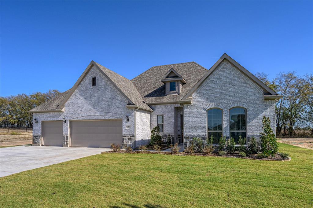 3 Beech Street Van Alstyne, TX 75495 - Photo 6 of 35 a front view of a house with a garden and yard