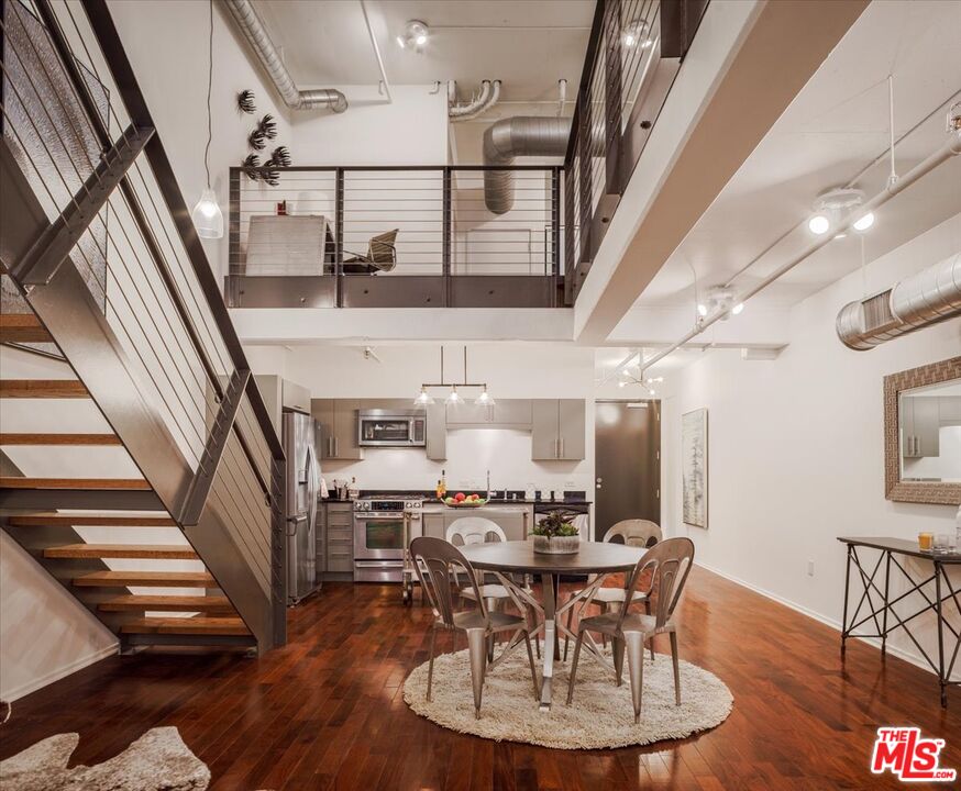 510 South Hewitt Street, Unit 106 Los Angeles, CA 90013 - Photo 2 of 26 a view of a dining room with furniture and wooden floor