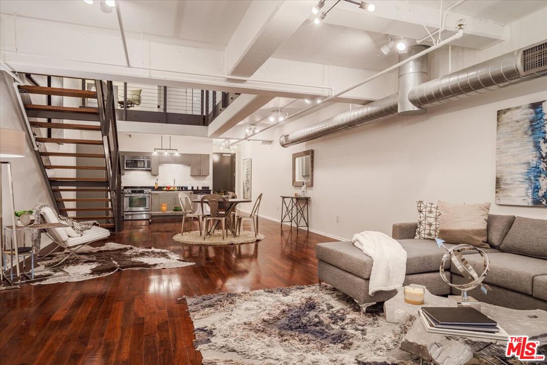 510 South Hewitt Street, Unit 106 Los Angeles, CA 90013 - Photo 7 of 26 a living room with lots of furniture and hard wood flooring