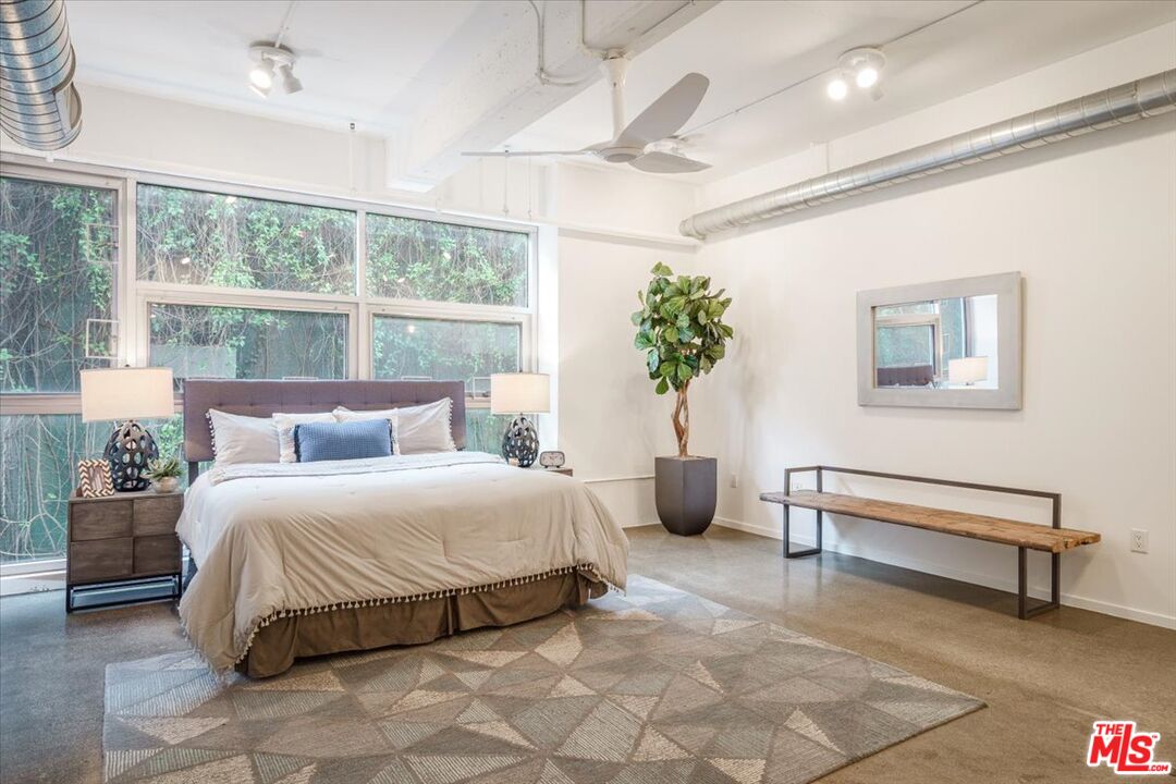 510 South Hewitt Street, Unit 106 Los Angeles, CA 90013 - Photo 10 of 26 a bedroom with a bed and a potted plant