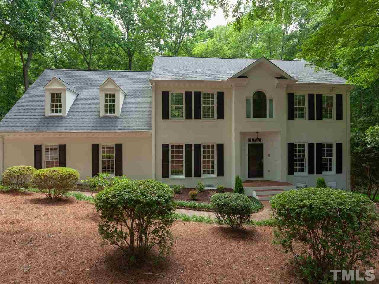 701 Presnell Court Raleigh, NC 27615 - Photo 2 of 24 a view of a white house with potted plants and a large tree