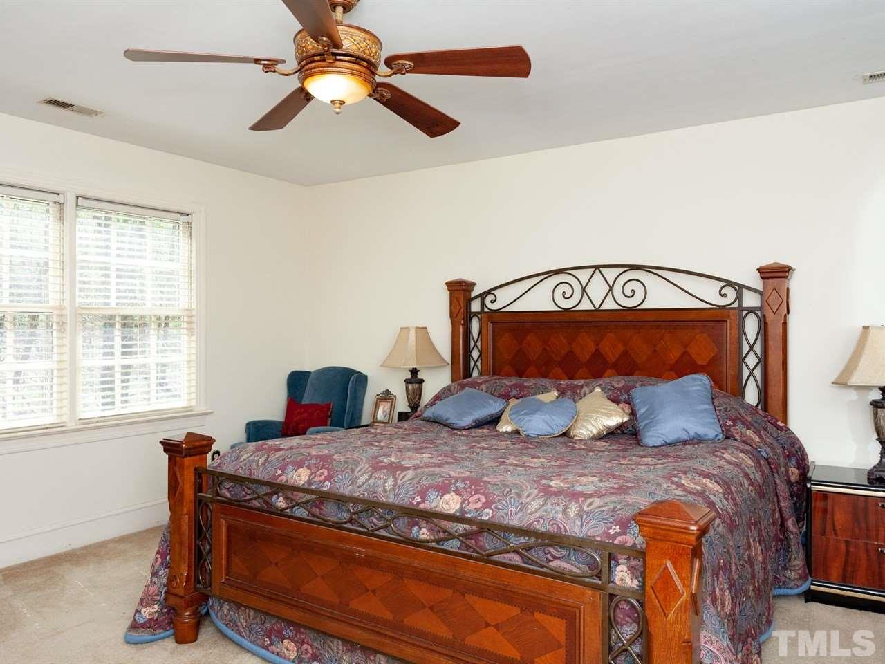 701 Presnell Court Raleigh, NC 27615 - Photo 13 of 24 a bedroom with a bed and window