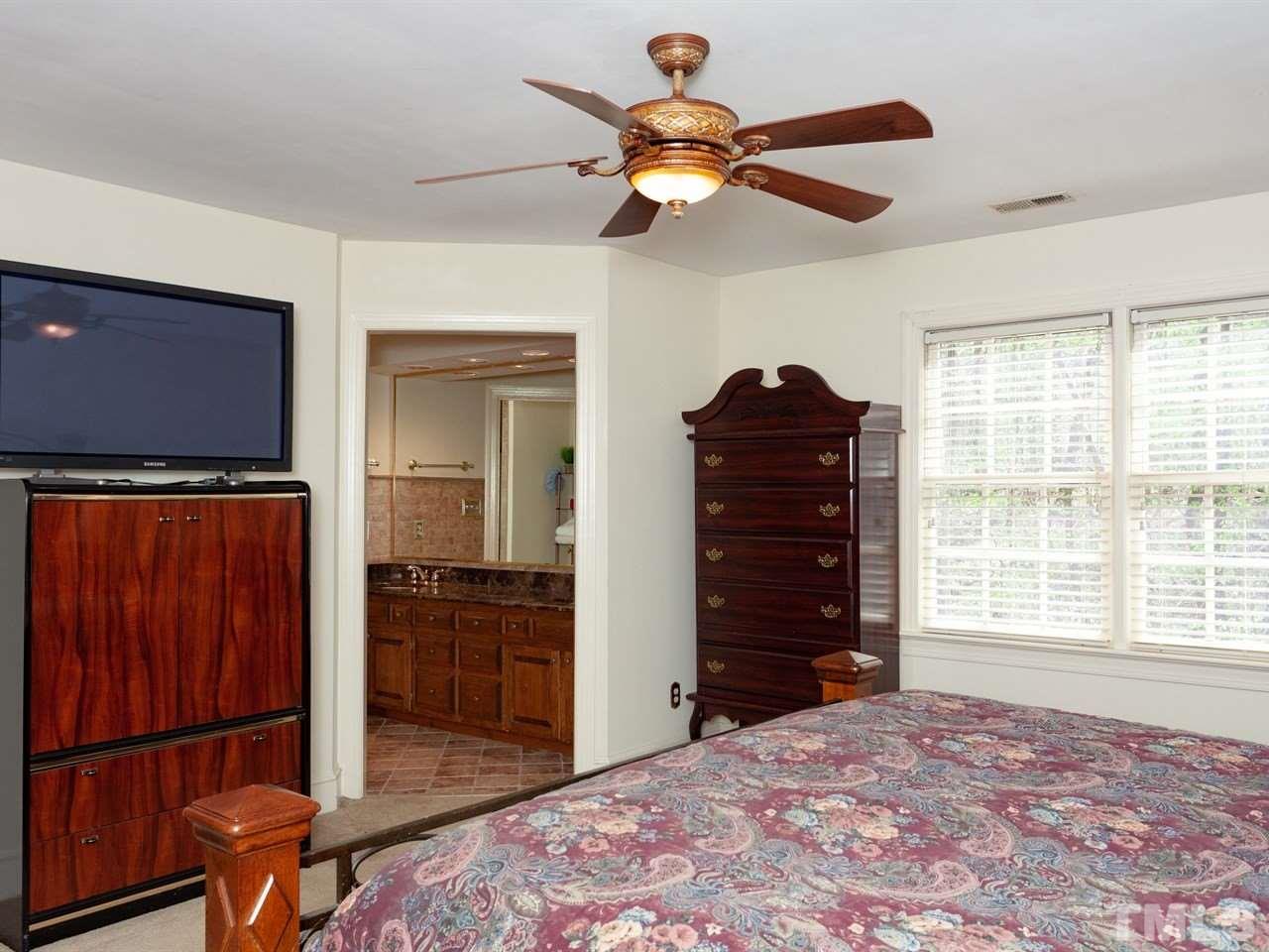 701 Presnell Court Raleigh, NC 27615 - Photo 14 of 24 a bedroom with a bed and a dresser