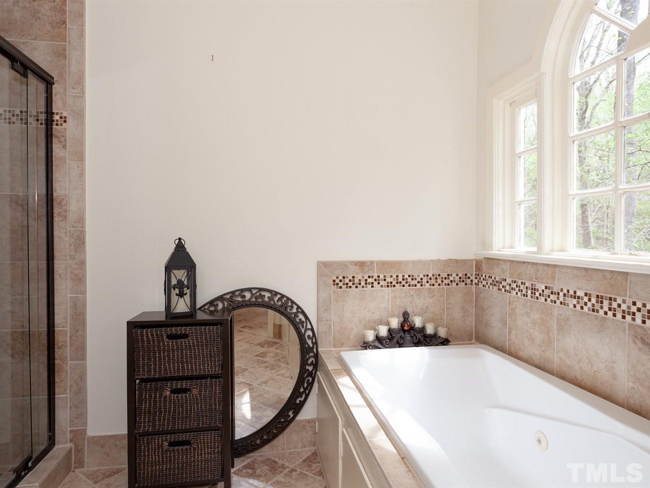 701 Presnell Court Raleigh, NC 27615 - Photo 16 of 24 a bathroom with a bathtub and a window