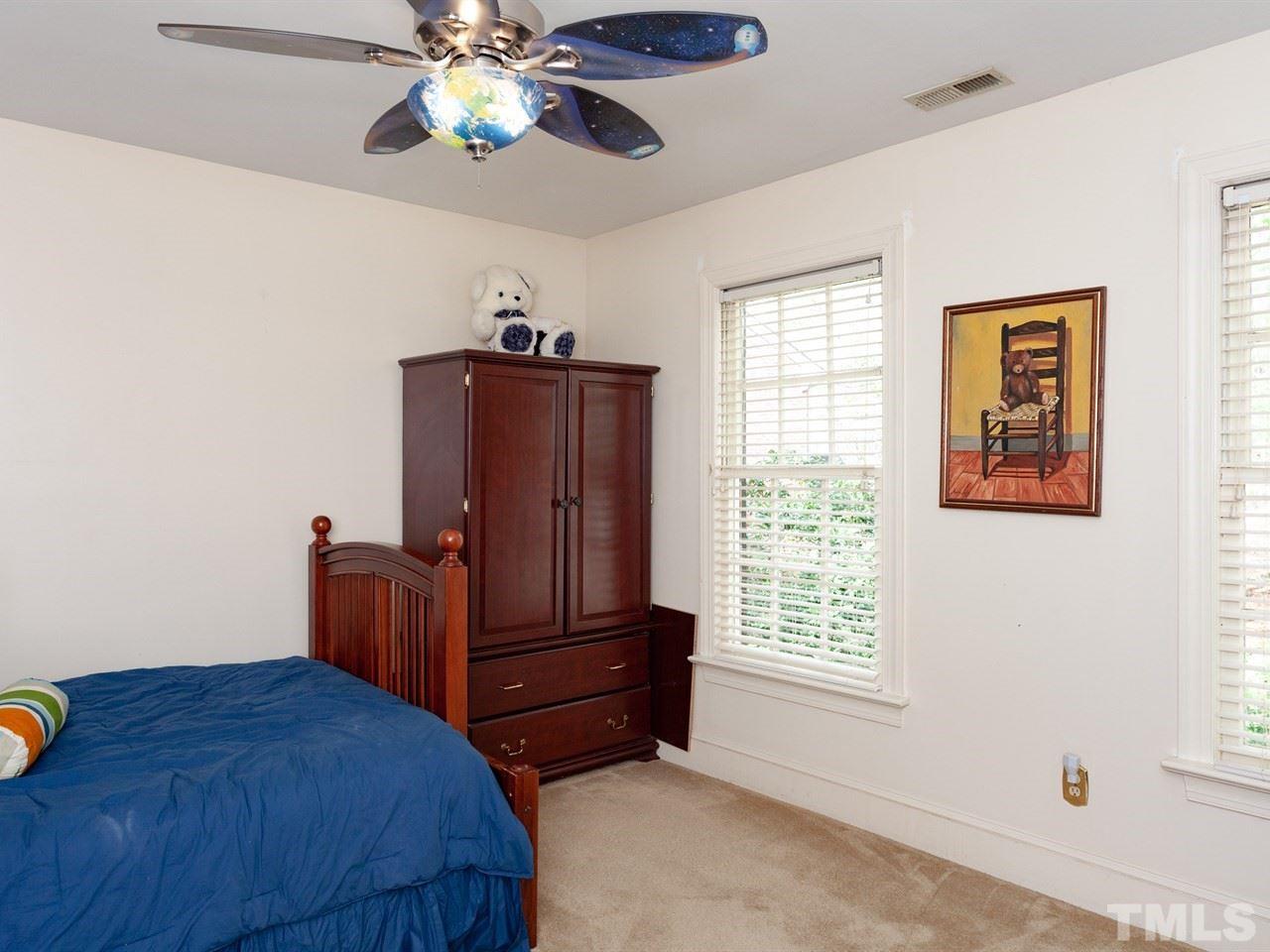 701 Presnell Court Raleigh, NC 27615 - Photo 17 of 24 a bedroom with a bed and wooden floor
