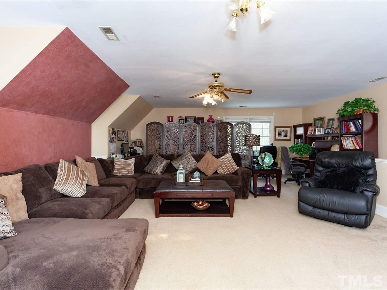 701 Presnell Court Raleigh, NC 27615 - Photo 21 of 24 a living room with furniture and a lamp