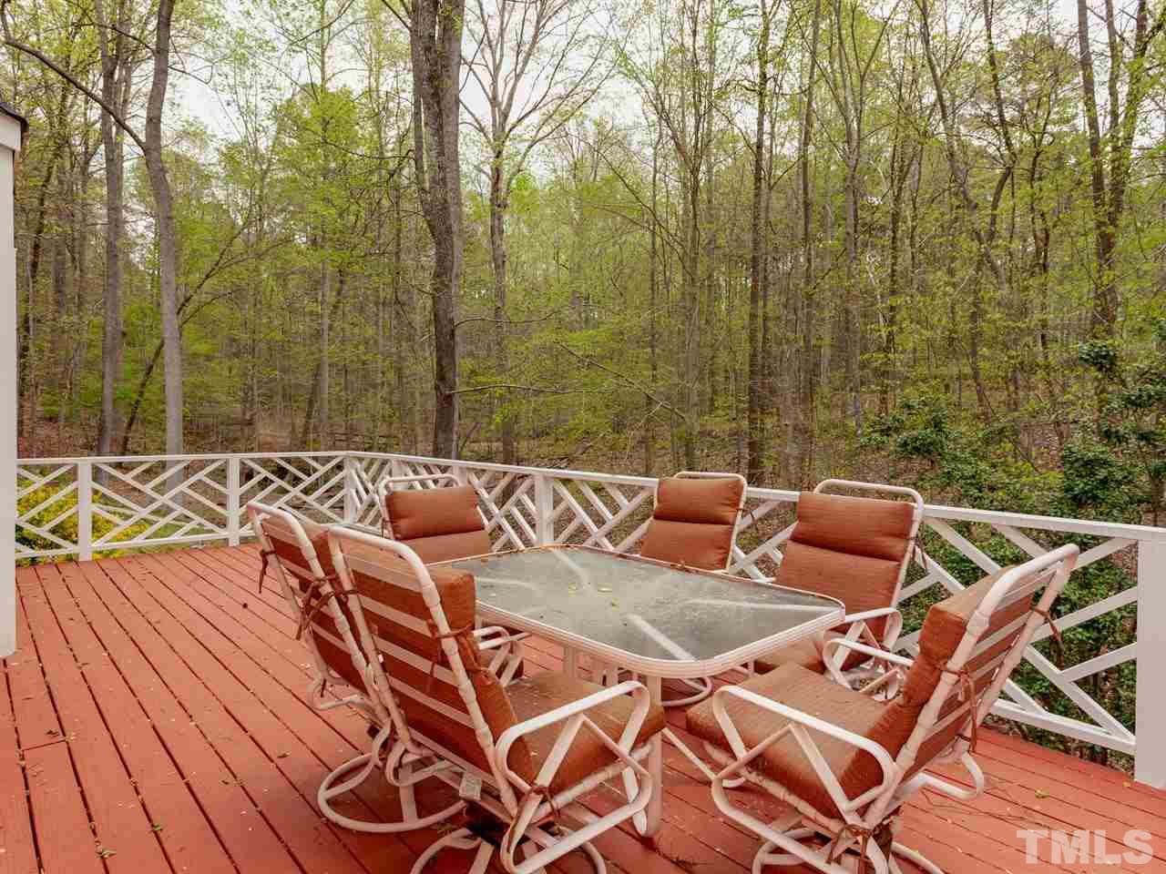 701 Presnell Court Raleigh, NC 27615 - Photo 22 of 24 a view of a patio with table and chairs with wooden floor and fence