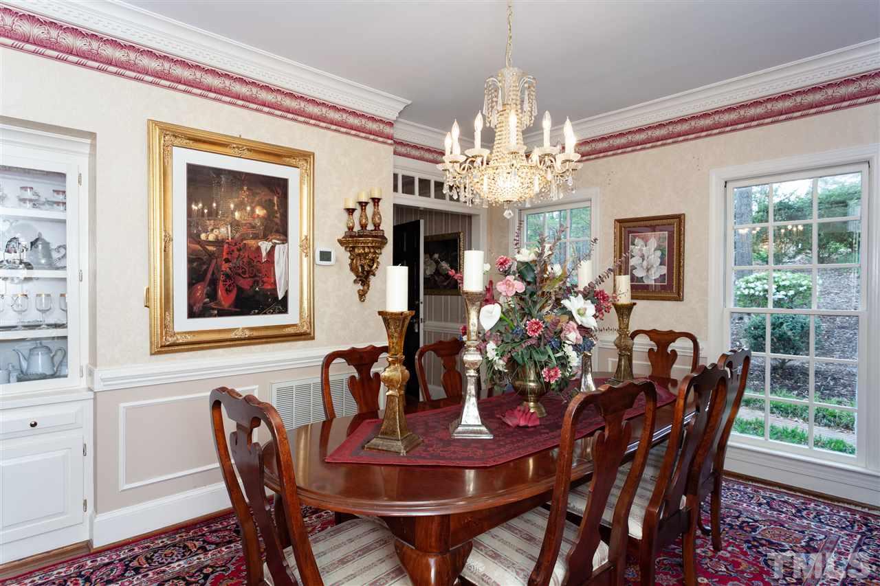 701 Presnell Court Raleigh, NC 27615 - Photo 7 of 24 a view of a dining room with furniture a chandelier and wooden floor