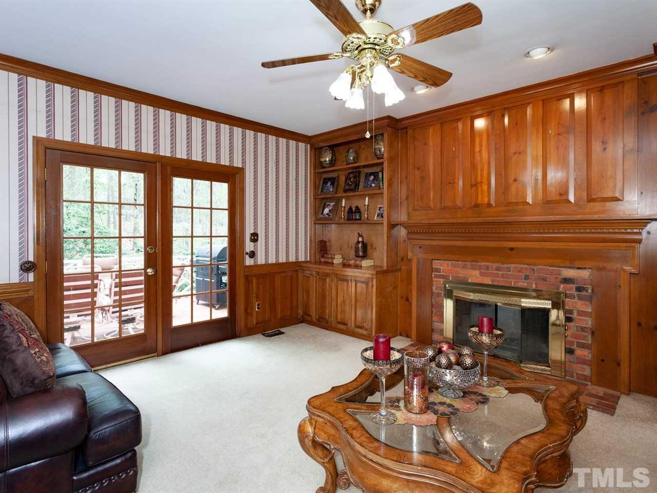 701 Presnell Court Raleigh, NC 27615 - Photo 10 of 24 a living room with furniture a fireplace and a chandelier