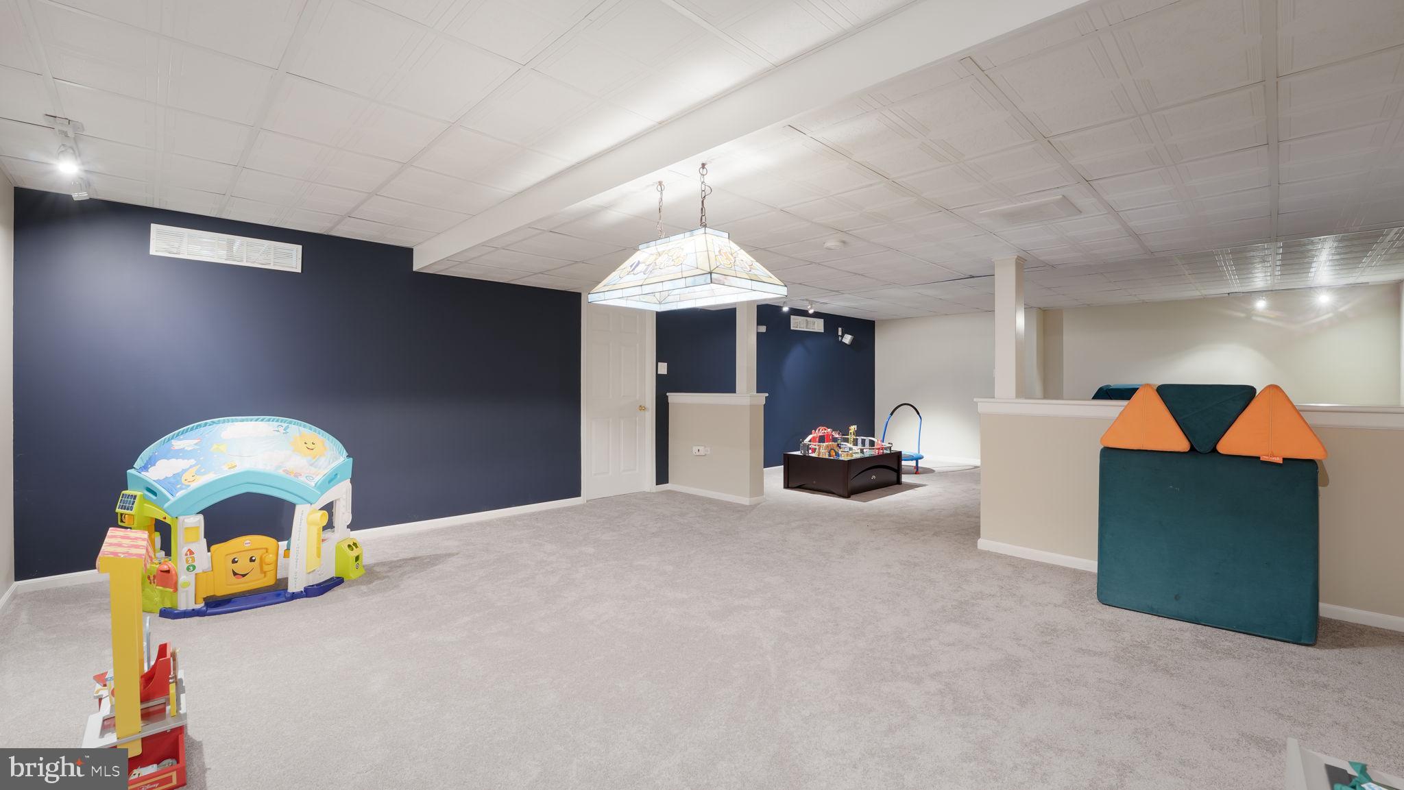 408 Longleaf Drive Perkasie, PA 18944 - Photo 27 of 36 a living room with furniture and a chandelier