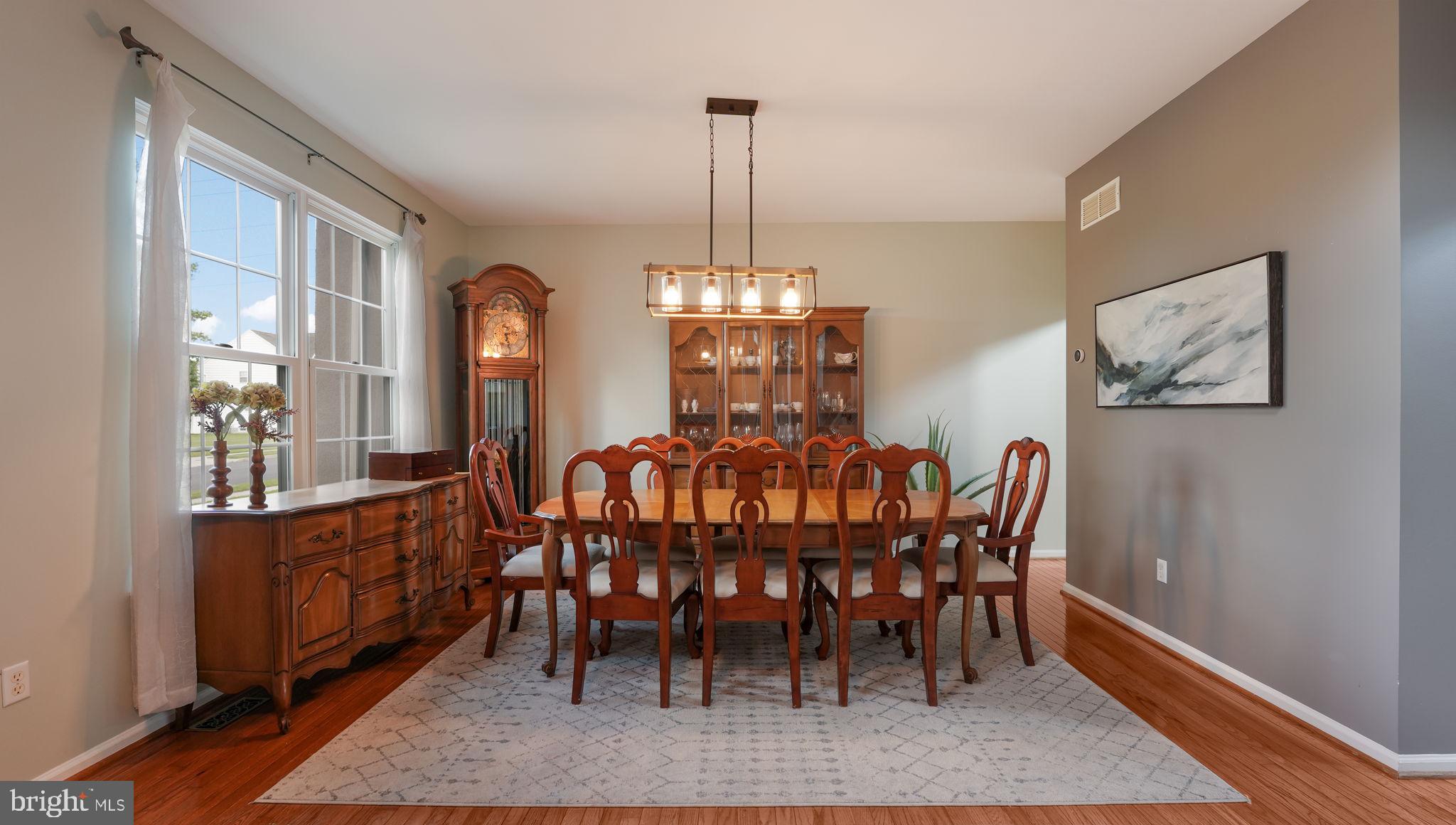 408 Longleaf Drive Perkasie, PA 18944 - Photo 5 of 36 a dining room with furniture a chandelier and wooden floor
