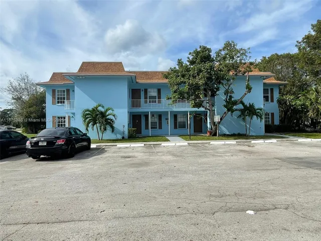 a car parked in front of a brick house