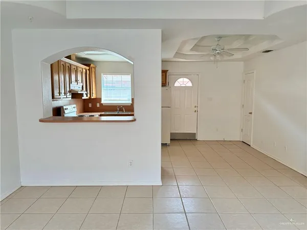 a view of a room with an entryway and chandelier
