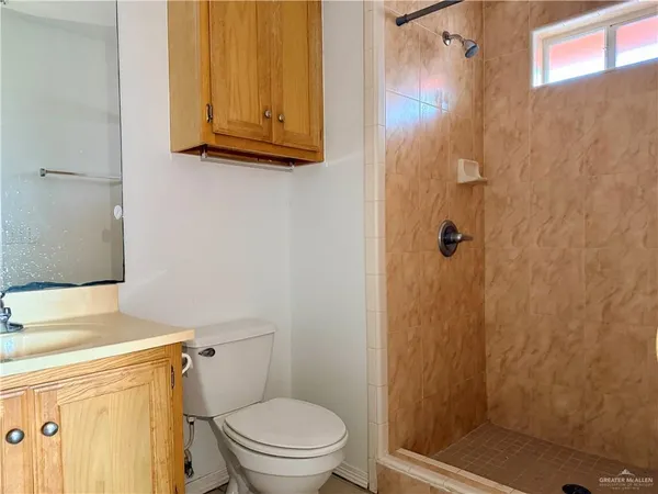 a bathroom with a toilet and a shower