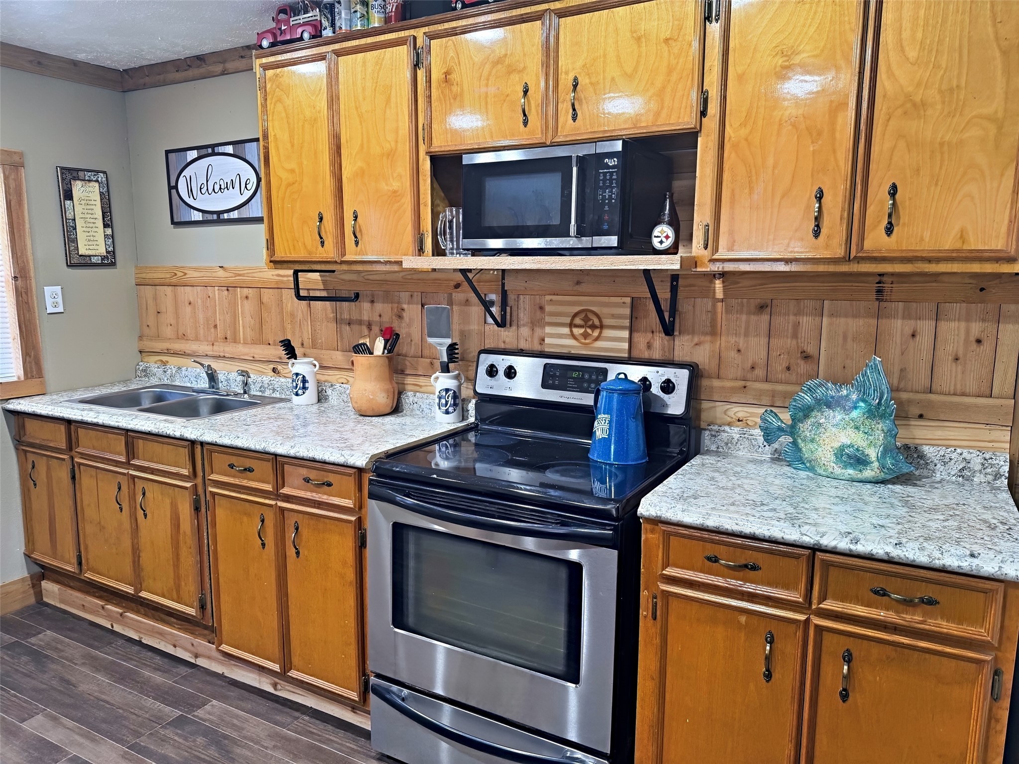 151 Canadian Drive Trinity, TX 75862 - Photo 7 of 19 a kitchen with stainless steel appliances granite countertop a stove microwave and cabinets