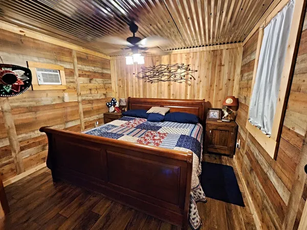 a living room with a couch wooden floor and a table