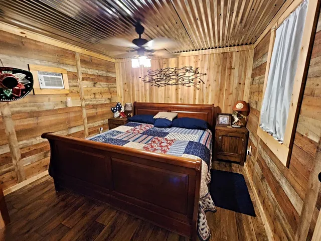 a living room with a couch wooden floor and a table