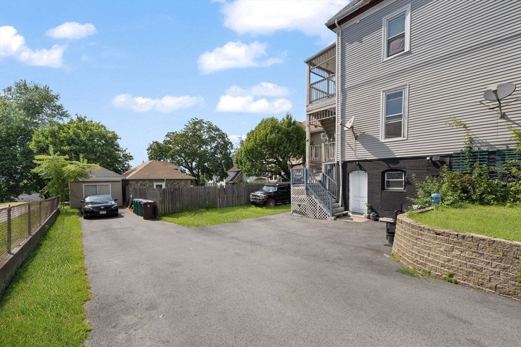311 Elm Street Woonsocket, RI 02895 - Photo 28 of 29 a front view of a house with a yard and garage