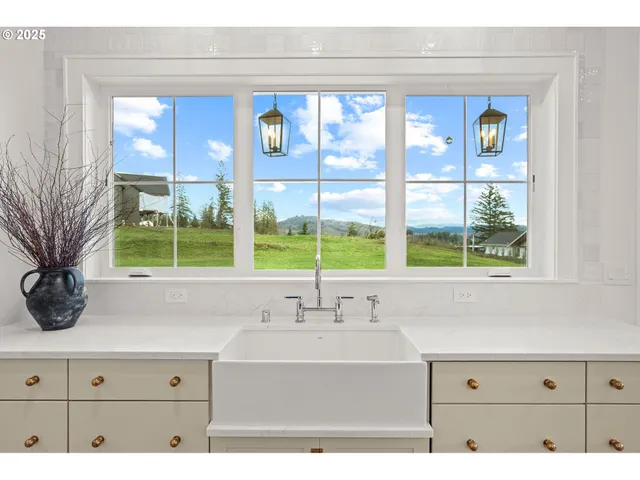 a sink with a window and mirror