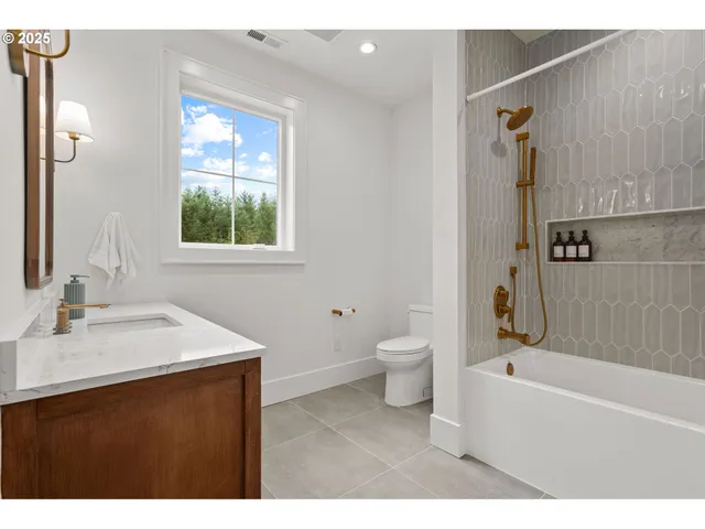 a bathroom with a sink toilet tub and shower