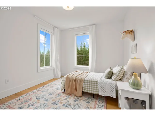 a bedroom with a bed lamp closet and window