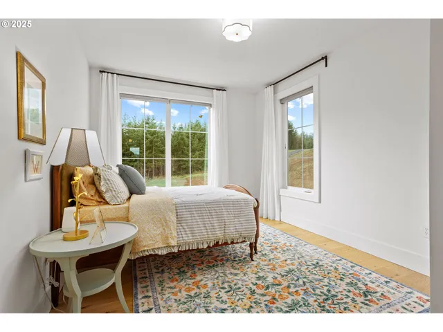a living room with a bed furniture and a window