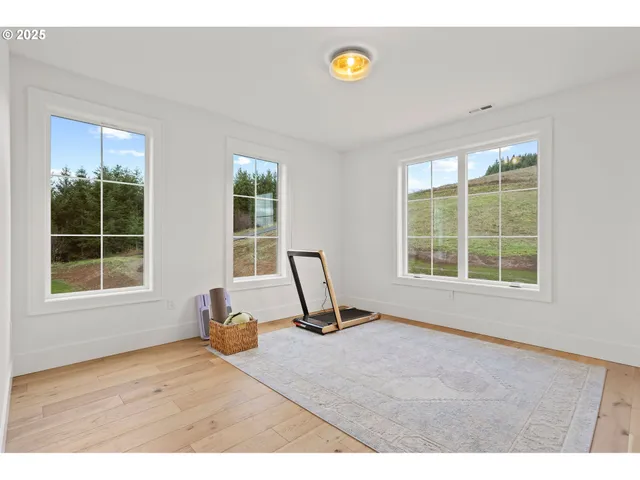 a view of a room with gym equipment and a window