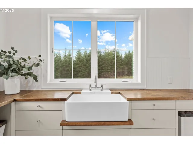 a sink with a window and a kitchen