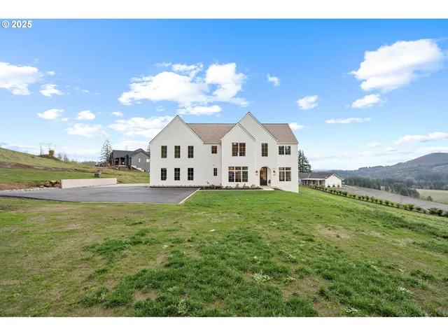 a view of a house with a yard and sitting area