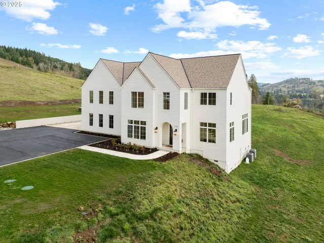 a view of a house with a yard and sitting area