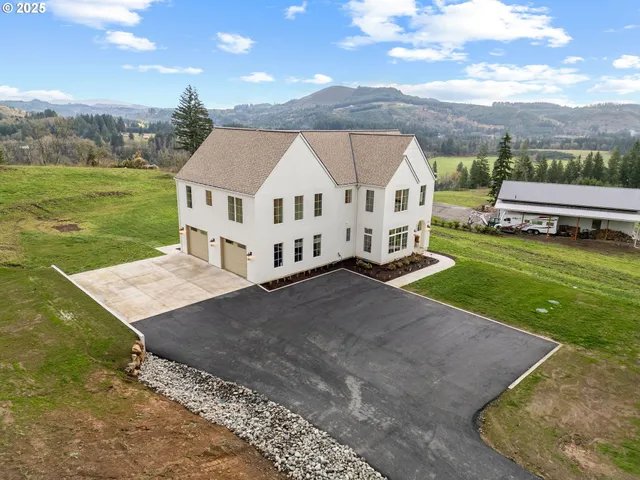 a aerial view of a house with a yard
