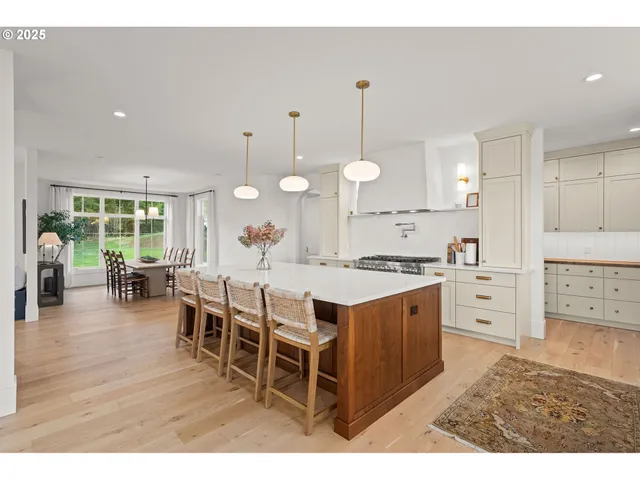 a large kitchen with lots of counter space a sink appliances and a large window