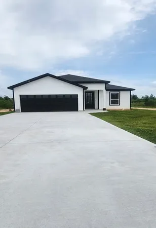 a view of backyard of house and trees